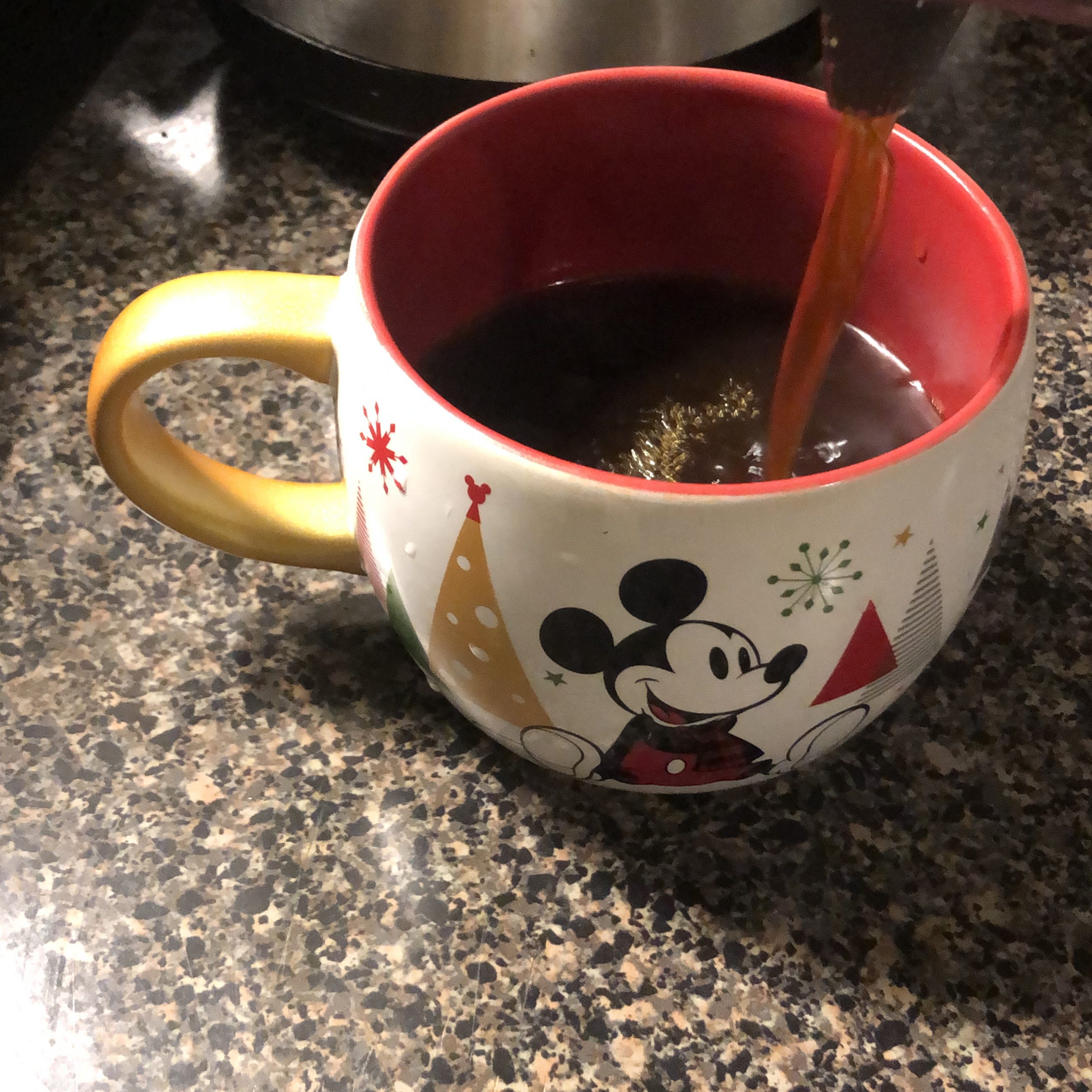 Christmas themed Mickey Mouse cup being filled with AIP "coffee"